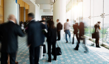 Business people talking and rushing in the lobby